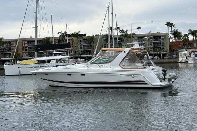 Slide: The Image of 2004 Formula 41 Performance Cruiser yacht docked in marina, surrounded by other boats. - 34