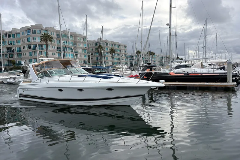 Slide: The Image of 2004 Formula 41 Performance Cruiser docked in a marina with modern buildings. - 35
