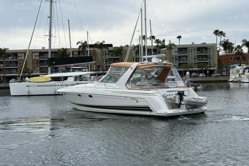 Slide: The Image of 2004 Formula 41 Performance Cruiser in marina, surrounded by sailboats and waterfront buildings. - 36