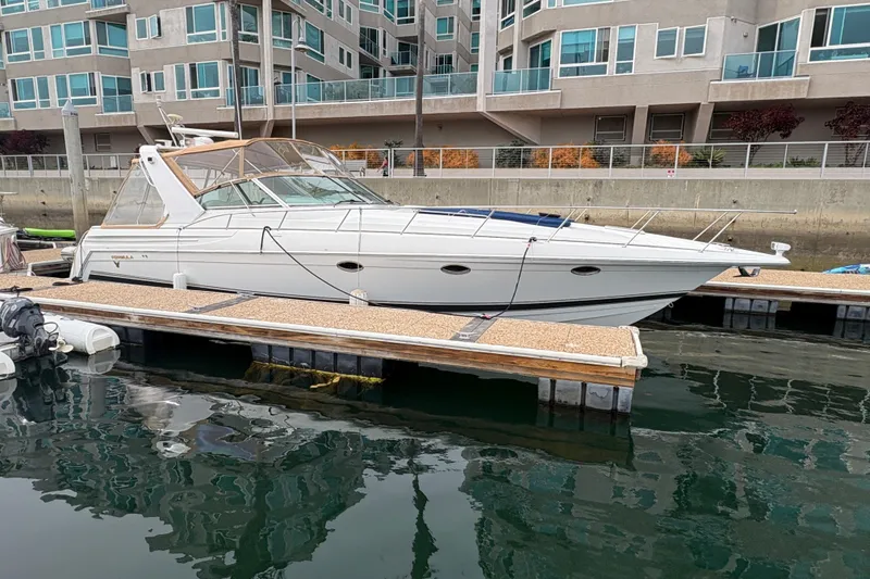 Slide: The Image of 2004 Formula 41 Performance Cruiser docked at marina, modern waterfront apartments in background. - 4
