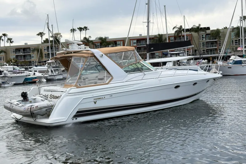 Slide: The Image of 2004 Formula 41 Performance Cruiser yacht docked in marina, surrounded by other boats. - 41