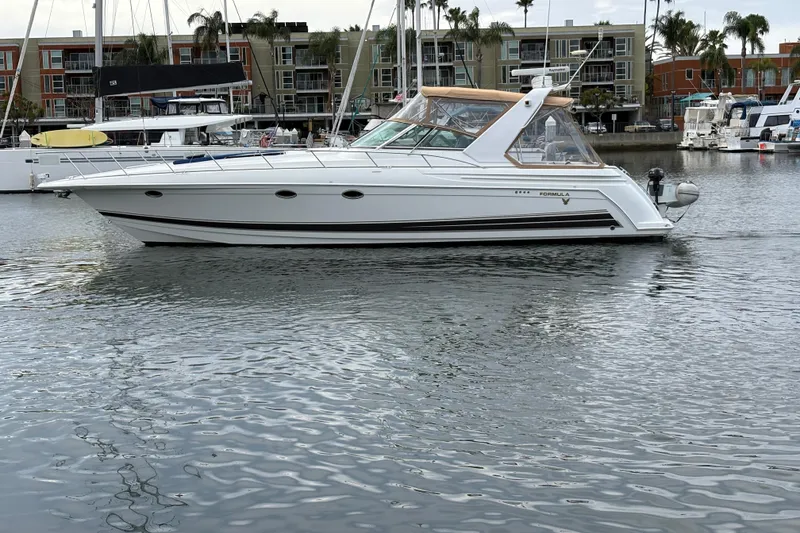 Slide: The Image of 2004 Formula 41 Performance Cruiser yacht docked in a marina with waterfront buildings. - 43