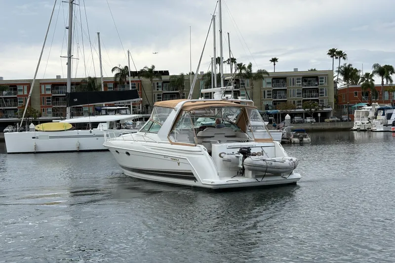 Slide: The Image of 2004 Formula 41 Performance Cruiser yacht docked in a marina with modern buildings. - 46