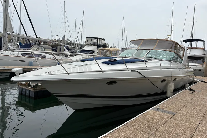 Slide: The Image of 2004 Formula 41 Performance Cruiser docked at marina with sailboats in background. - 5
