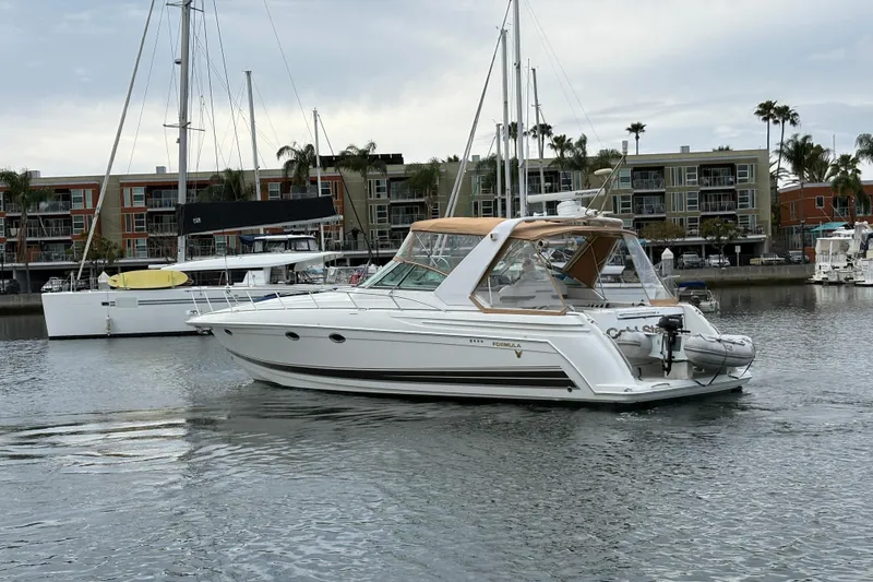 Slide: The Image of 2004 Formula 41 Performance Cruiser in marina, surrounded by sailboats and waterfront buildings. - 51