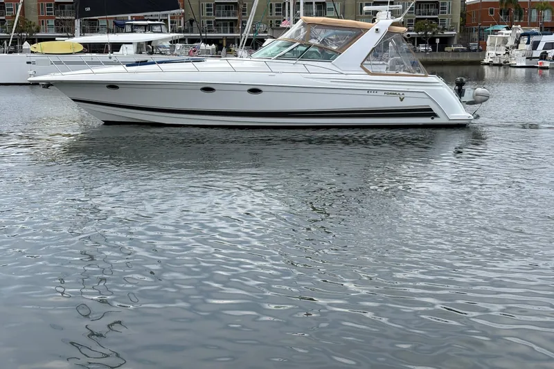 Slide: The Image of 2004 Formula 41 Performance Cruiser on calm water, showcasing sleek design and luxury features. - 53