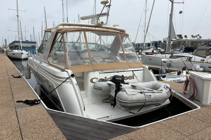 Slide: The Image of 2004 Formula 41 Performance Cruiser docked at marina with inflatable boat attached. - 6