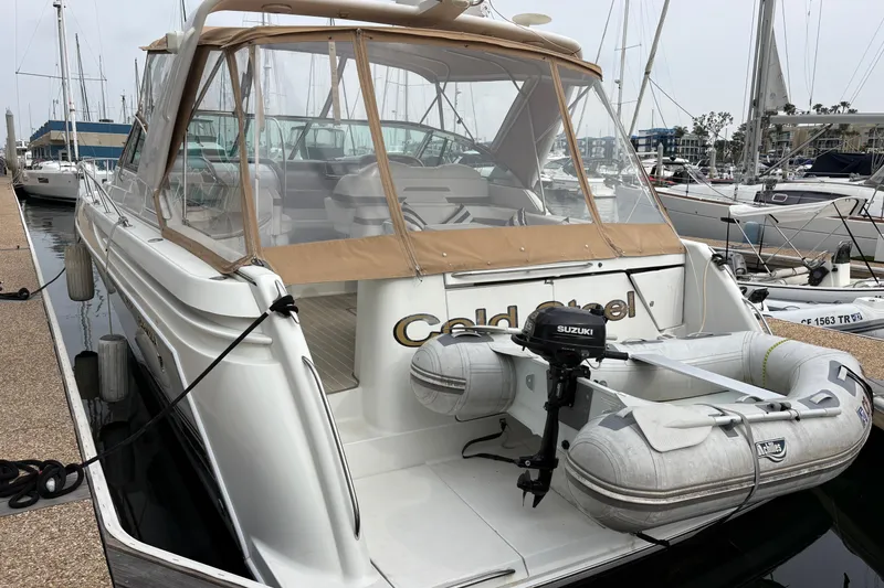 Slide: The Image of 2004 Formula 41 Performance Cruiser docked with inflatable boat and Suzuki motor. - 7