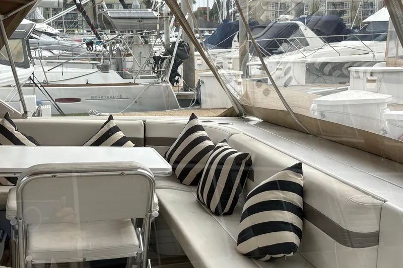 Slide: The Image of Interior of 2004 Formula 41 Performance Cruiser with striped cushions and marina view. - 9