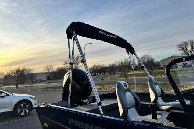 Slide: The Image of 2026 Princecraft Holiday 162 WS MAX boat parked near a white car at sunset. - 13