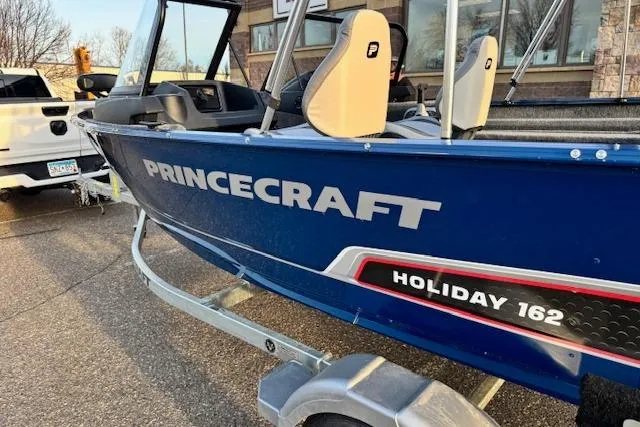 Slide: The Image of 2026 Princecraft Holiday 162 WS MAX boat on trailer, blue exterior, parked outdoors. - 4
