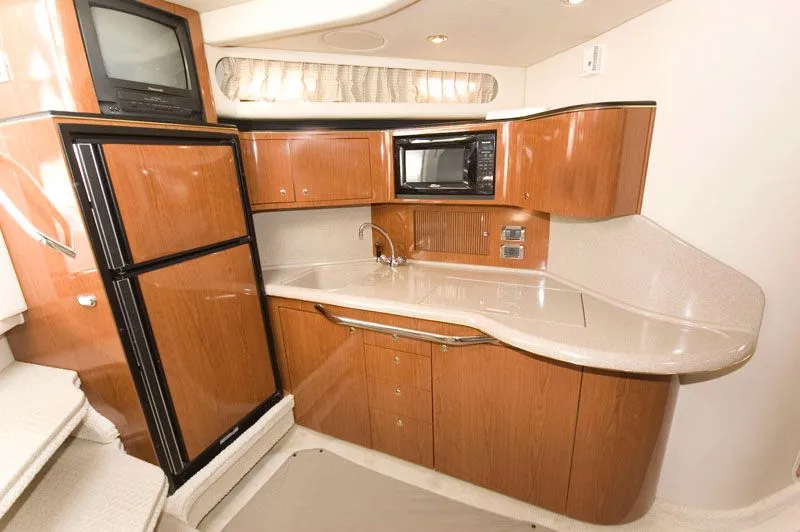 Slide: The Image of Interior of 2002 Sea Ray 380 Sundancer with kitchen and appliances. - 4
