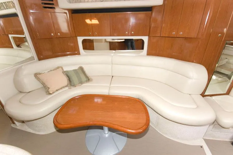 Slide: The Image of Interior of 2002 Sea Ray 380 Sundancer with leather sofa and wooden table. - 5