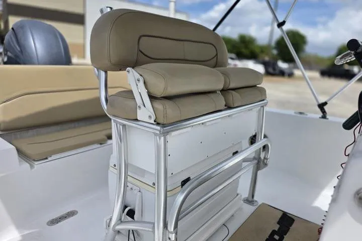 Slide: The Image of 2016 Sportmans Masters 227 Bay Boat interior with cushioned seating and sleek design. - 12