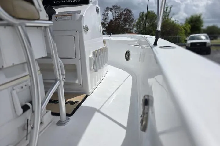 Slide: The Image of 2016 Sportmans Masters 227 Bay Boat interior with seating and storage compartments. - 13