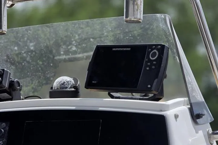 Slide: The Image of Dashboard of a 2016 Sportmans Masters 227 Bay Boat with navigation equipment. - 14