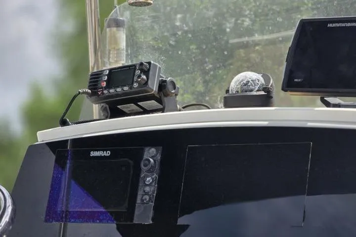 Slide: The Image of 2016 Sportmans Masters 227 Bay Boat dashboard with navigation and communication equipment. - 15