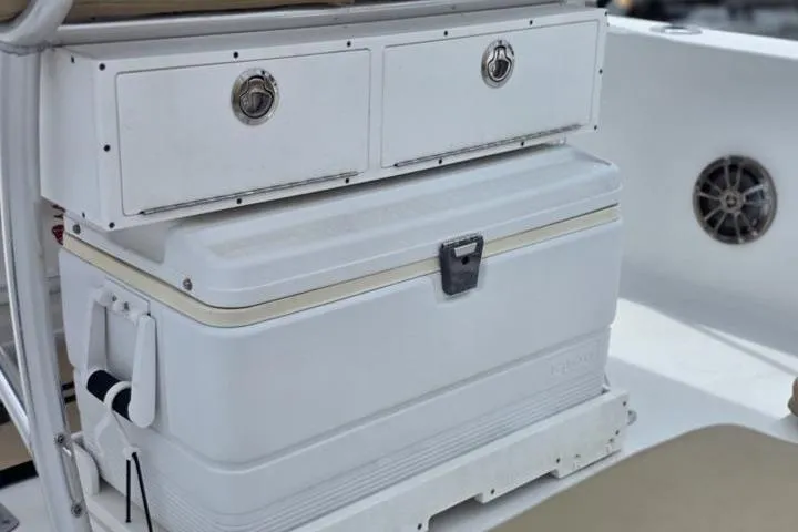 Slide: The Image of 2016 Sportmans Masters 227 Bay Boat interior with storage compartments and cooler. - 17