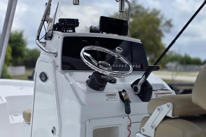 Slide: The Image of 2016 Sportmans Masters 227 Bay Boat console with steering wheel and controls. - 18