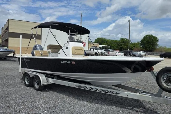 Slide: The Image of 2016 Sportmans Masters 227 Bay Boat on trailer, parked outdoors under cloudy sky. - 7