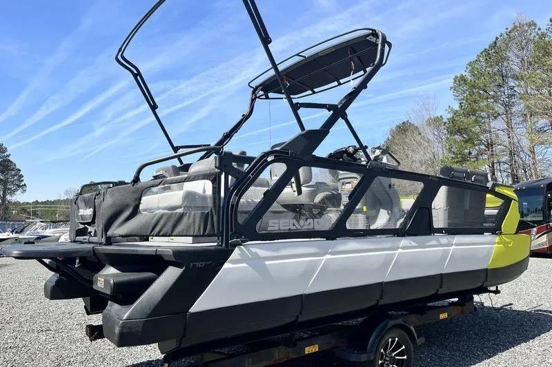 Slide: The Image of 2022 Sea-Doo Switch Cruise 21 pontoon boat on trailer, parked outdoors. - 3