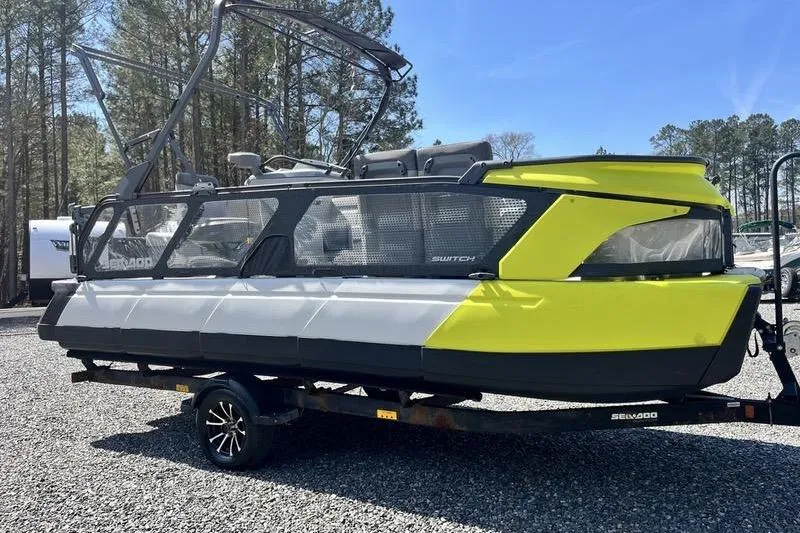 Slide: The Image of 2022 Sea-Doo Switch Cruise 21 pontoon boat on trailer, parked outdoors. - 4
