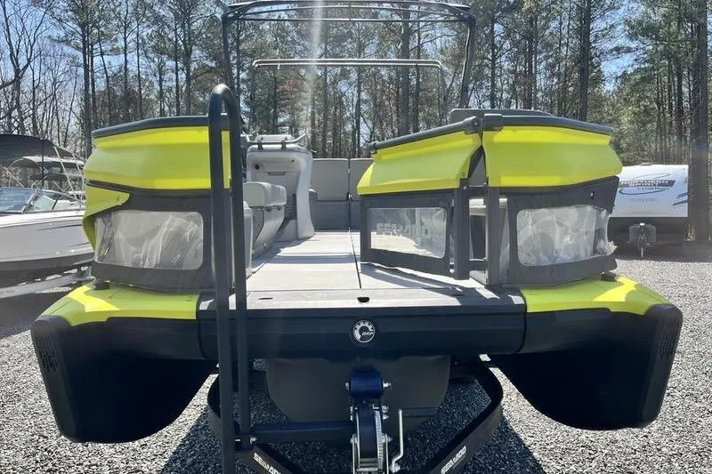 Slide: The Image of 2022 Sea-Doo Switch Cruise 21 pontoon boat, vibrant yellow, parked outdoors. - 5
