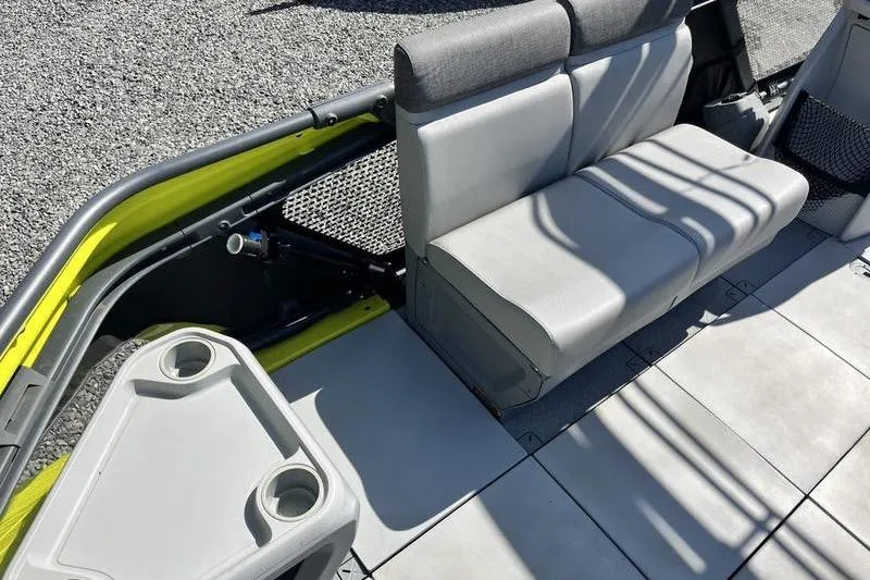 Slide: The Image of 2022 Sea-Doo Switch Cruise 21 interior with gray seating and cup holders. - 6