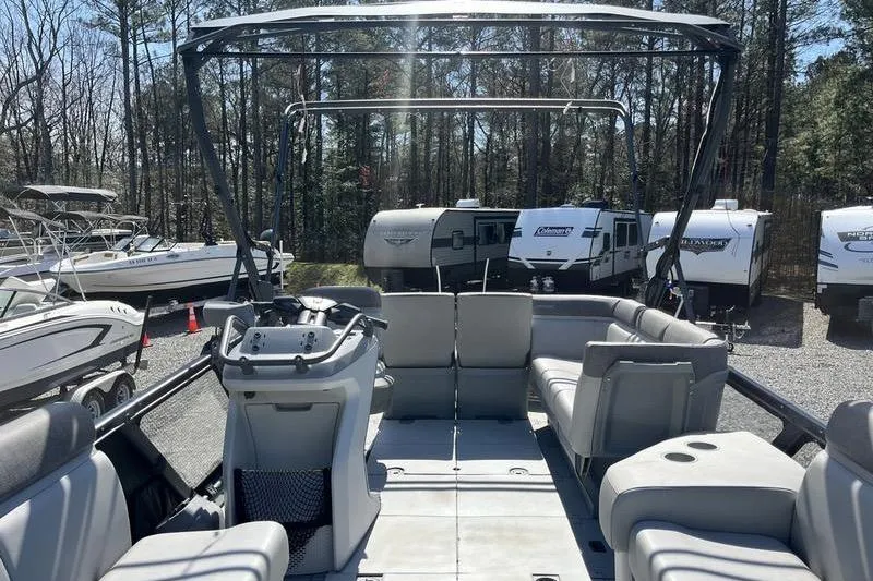 Slide: The Image of 2022 Sea-Doo Switch Cruise 21 interior with seating and control console, parked outdoors. - 8