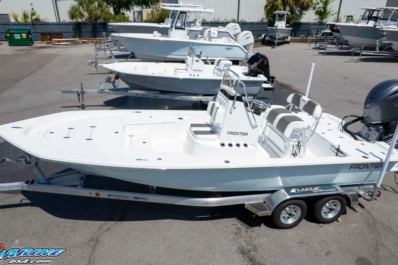 Slide: The Image of 2025 Frontier 2104 boat on trailer in marina, showcasing sleek design and modern features. - 10