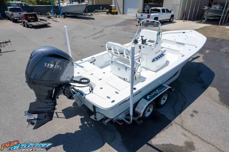 Slide: The Image of 2025 Frontier 2104 boat with Yamaha engine on trailer in marina setting. - 17