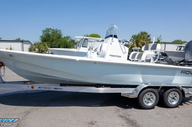 Slide: The Image of 2025 Frontier 2104 boat on trailer, parked outdoors under clear sky. - 9