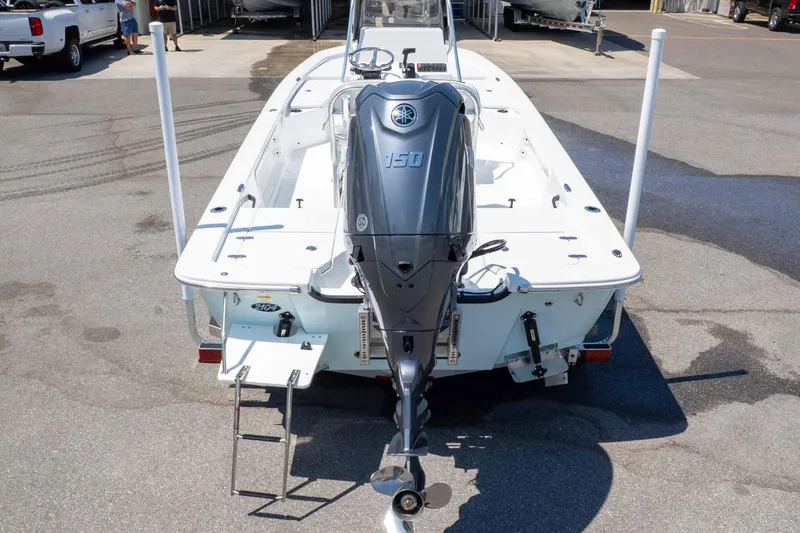 Slide: The Image of 2025 Frontier 2104 boat with Yamaha 150 outboard motor, parked on concrete. - 13