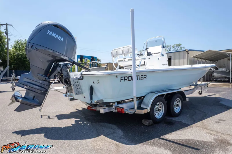 Slide: The Image of 2025 Frontier 2104 boat with Yamaha engine on trailer in sunny outdoor setting. - 15