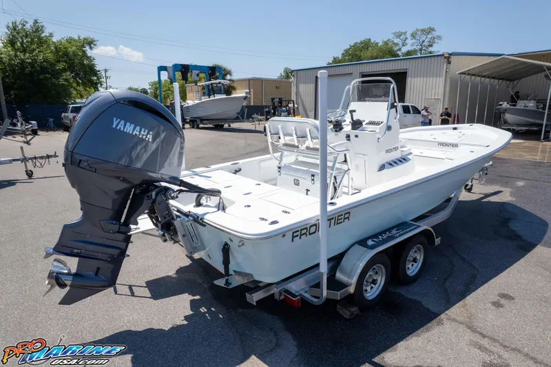 Slide: The Image of 2025 Frontier 2104 boat with Yamaha engine on trailer in marina setting. - 16