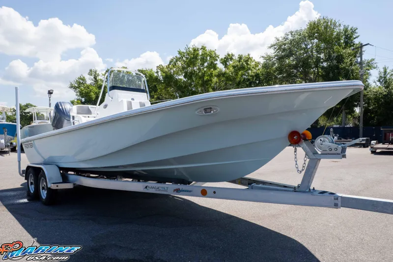 Slide: The Image of 2025 Frontier 2104 boat on trailer, parked outdoors under a clear sky. - 20