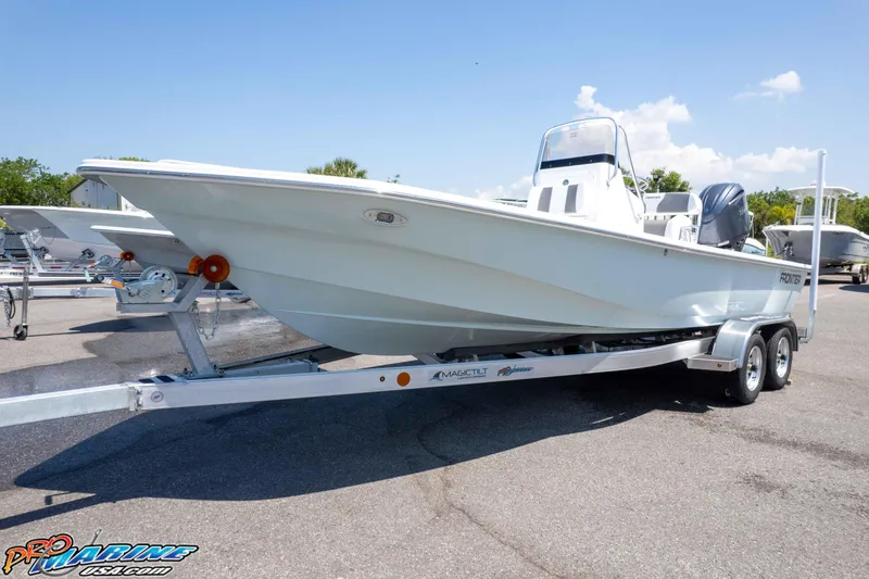 Slide: The Image of 2025 Frontier 2104 boat on trailer under clear blue sky. - 7