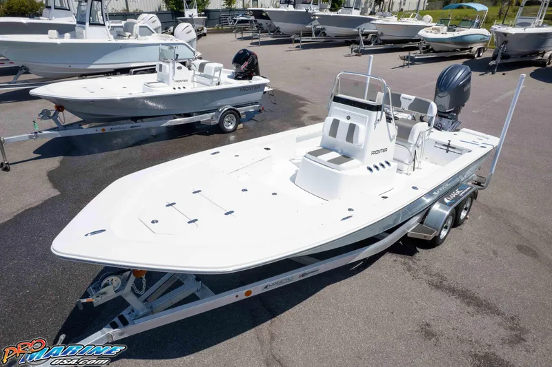 Slide: The Image of 2025 Frontier 2104 boat on trailer in marina parking lot. - 8