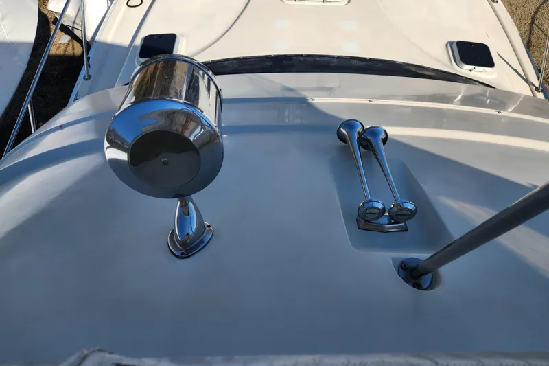 Slide: The Image of 1987 Luhrs 40 Convertible boat interior with covered controls and marina view. - 16