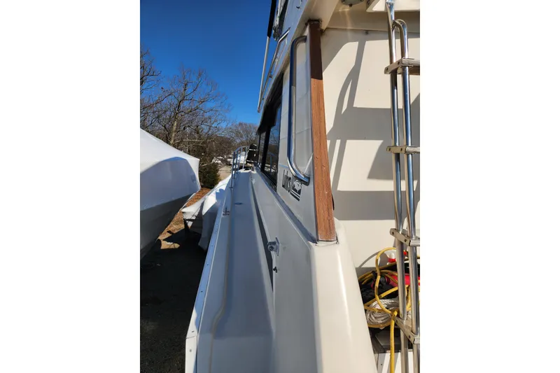 Slide: The Image of View from 1987 Luhrs 40 Convertible boat, overlooking covered boats in a marina. - 19