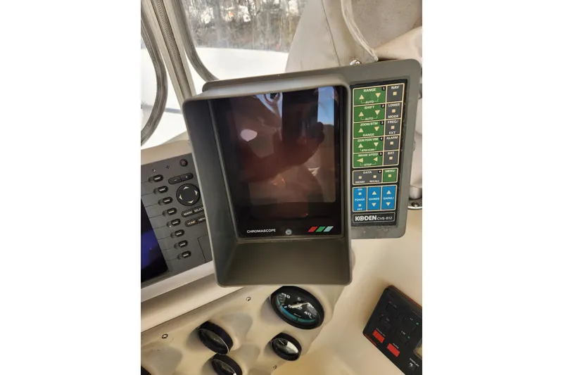 Slide: The Image of 1987 Luhrs 40 Convertible boat dashboard with Koden CVS-812 display and controls. - 27
