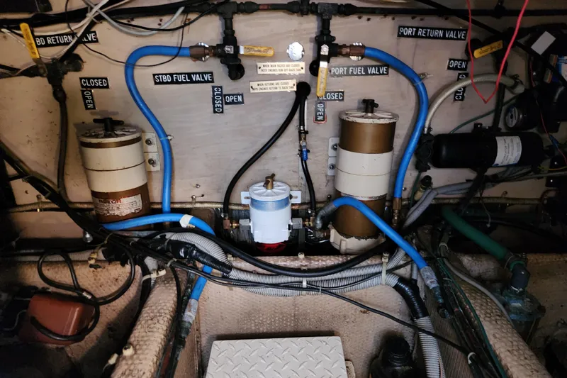 Slide: The Image of Engine room of 1987 Luhrs 40 Convertible with labeled fuel valves and filters. - 39