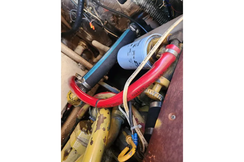 Slide: The Image of Engine compartment of a 1987 Luhrs 40 Convertible boat, showing hoses and filter. - 40