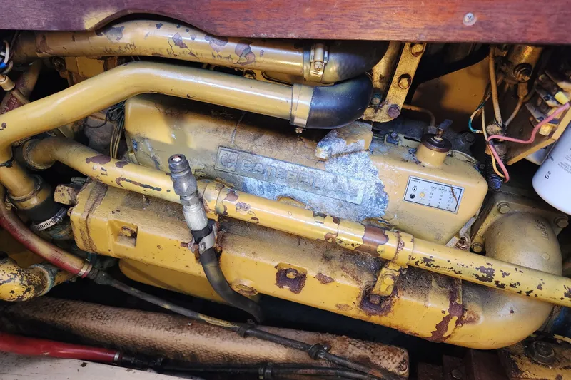 Slide: The Image of Engine compartment of a 1987 Luhrs 40 Convertible boat, featuring a Caterpillar engine. - 42