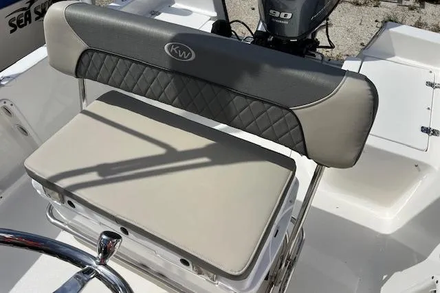 Slide: The Image of 2025 Key West 1720 Center Console boat seat with KW logo and motor in background. - 3