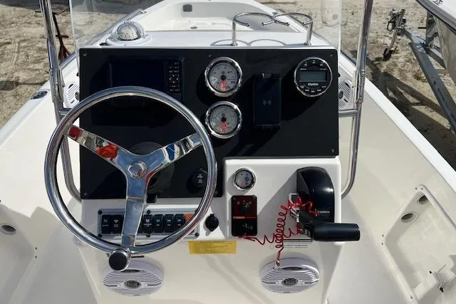 Slide: The Image of 2025 Key West 1720 Center Console boat dashboard with steering wheel and gauges. - 4