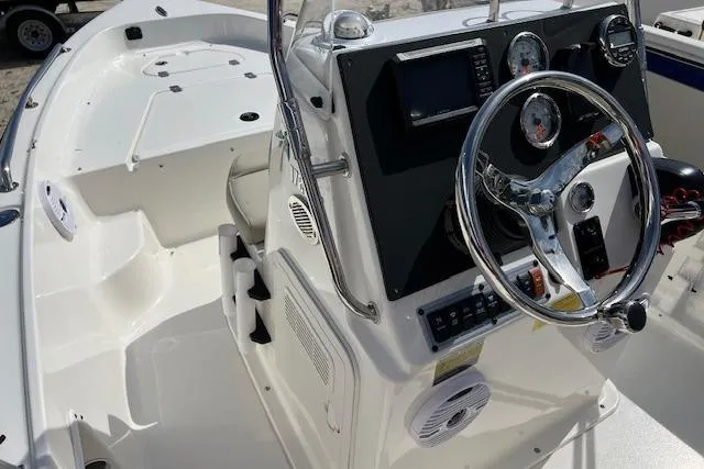 Slide: The Image of 2025 Key West 1720 Center Console boat interior with steering wheel and dashboard controls. - 6