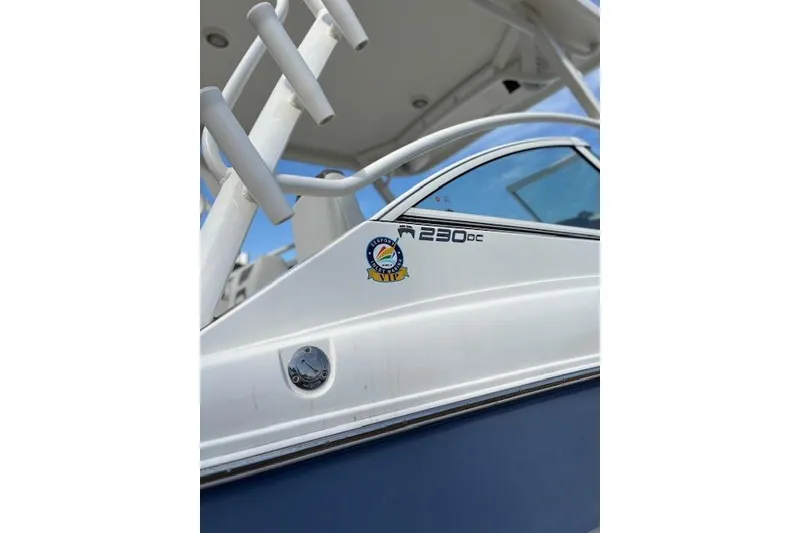 Slide: The Image of 2023 World Cat 230 DC boat, close-up of side detailing and logo. - 2