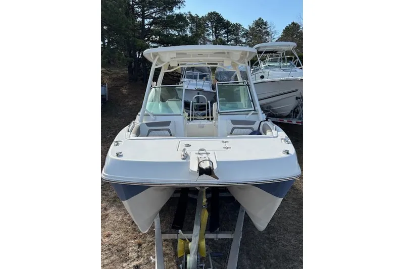 Slide: The Image of 2023 World Cat 230 DC boat on trailer, front view, outdoors. - 3