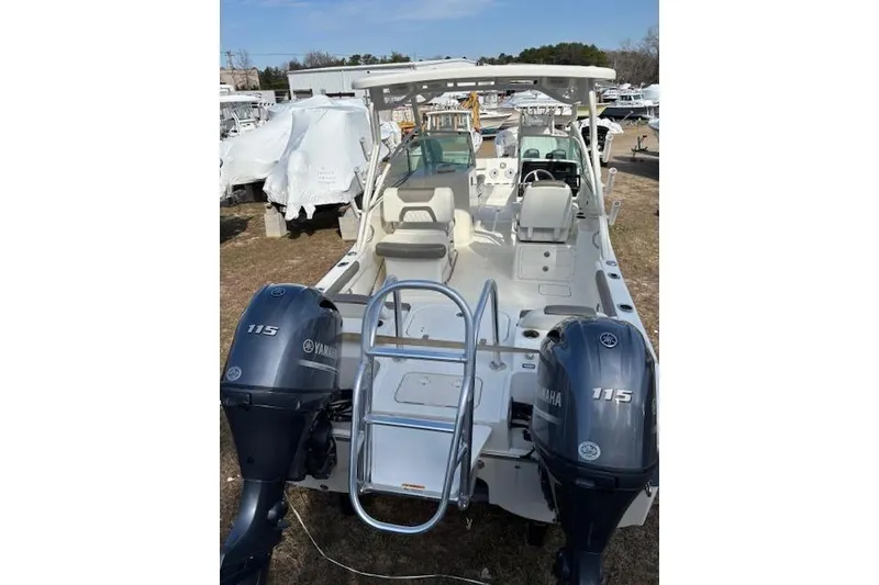 Slide: The Image of 2023 World Cat 230 DC boat with dual Yamaha 115 engines, docked outdoors. - 4